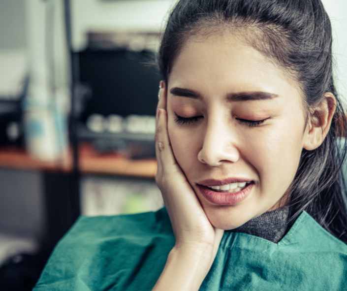 Patient receiving a gentle tooth extraction in a modern dental office