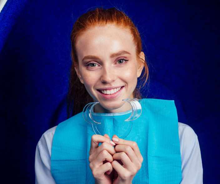 Dentist performing in-office teeth whitening procedure